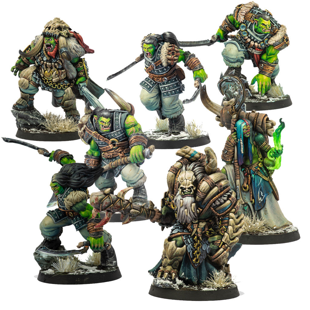 Six painted miniature figures of fierce green orc warriors and shamans in winter armor