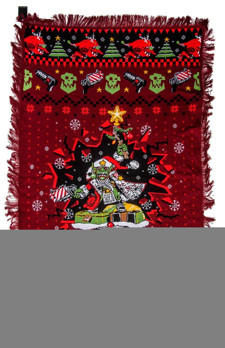 A red knitted blanket featuring a Warhammer 40000 ugly sweater Christmas design with a Santa Gobbo, weapons, skulls, and reindeer