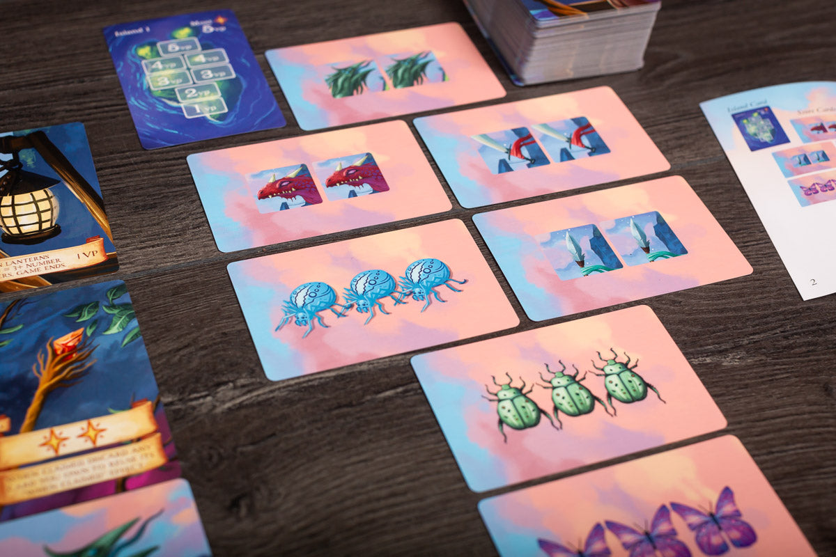 Close-up image focusing on detailed game cards and tokens used in Isle of Night, highlighting artwork and iconography