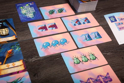 Close-up image focusing on detailed game cards and tokens used in Isle of Night, highlighting artwork and iconography