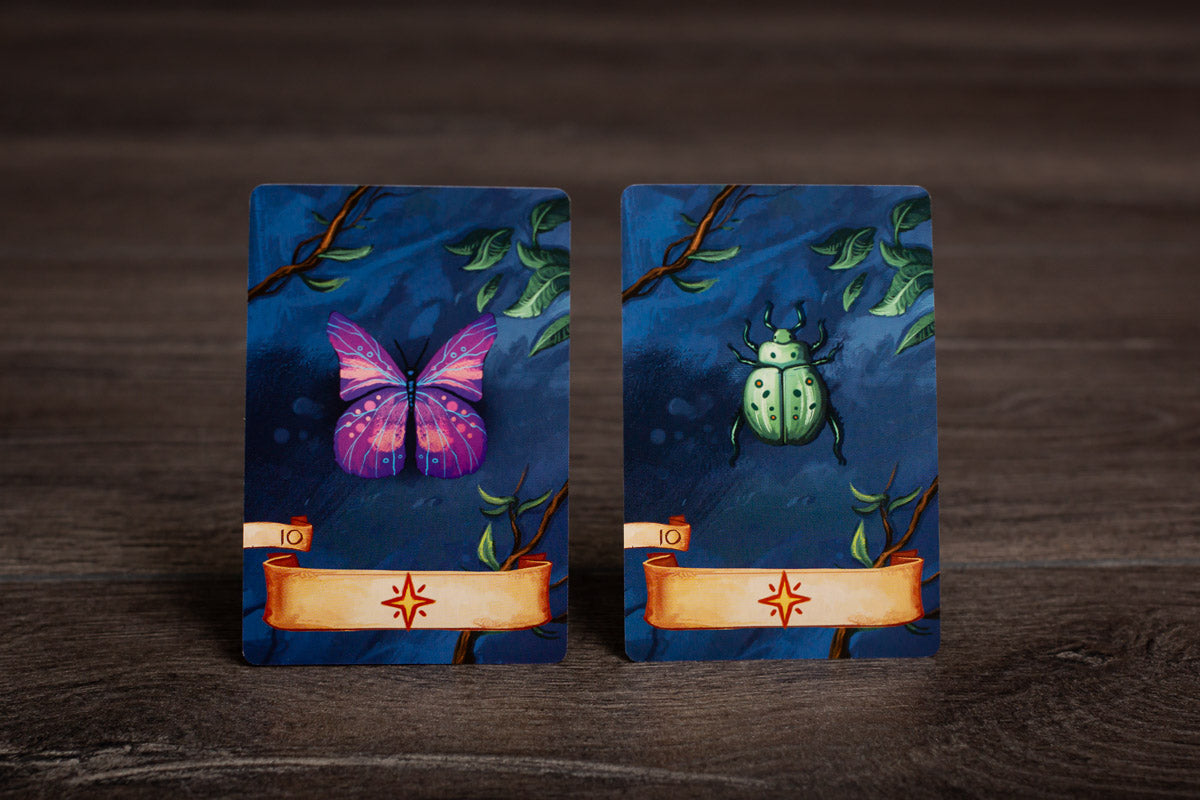 A close-up shot of miniatures and tokens placed on the Isle of Night game board during active play