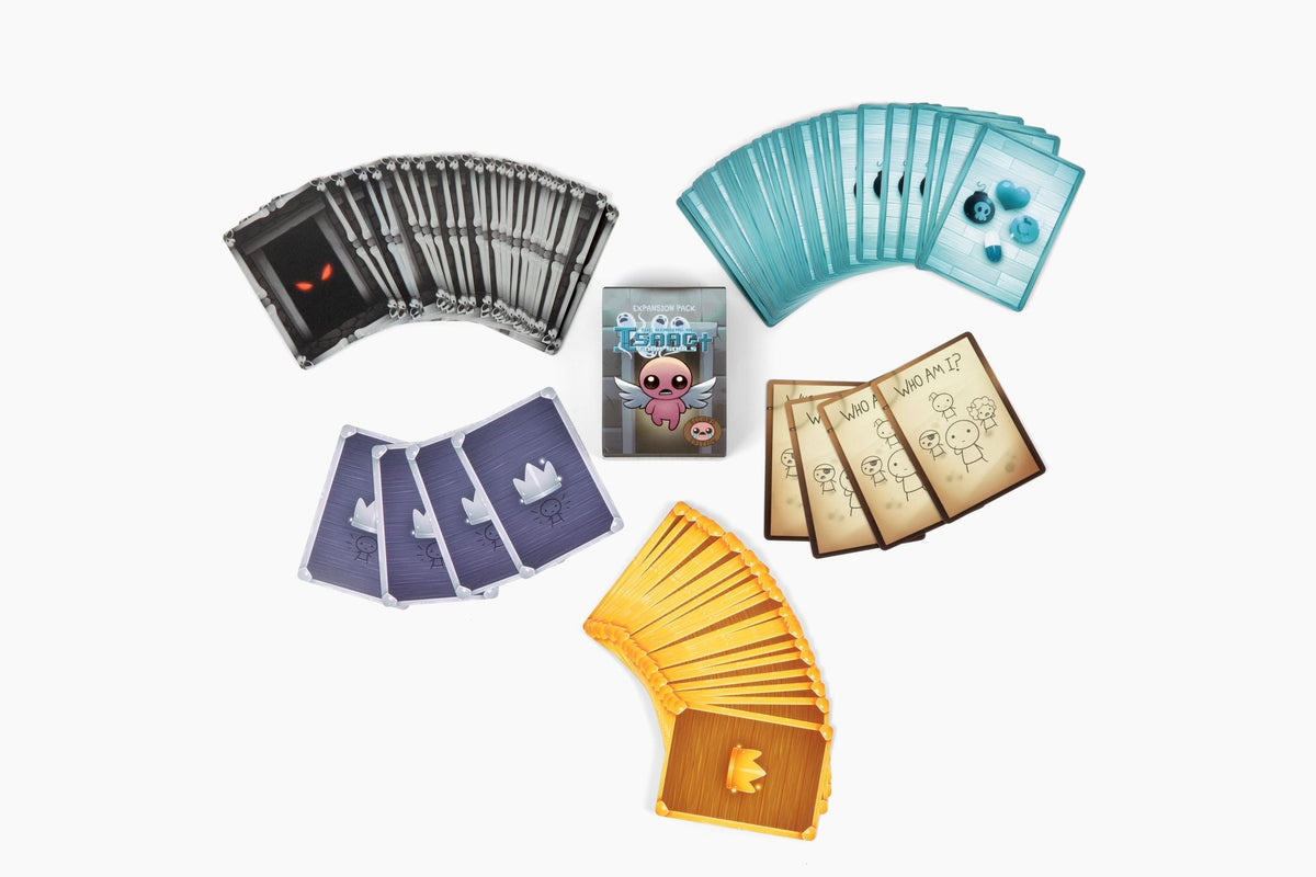 A top-down view of The Binding of Isaac: Four Souls expansion box, surrounded by fanned-out decks of colorful game cards