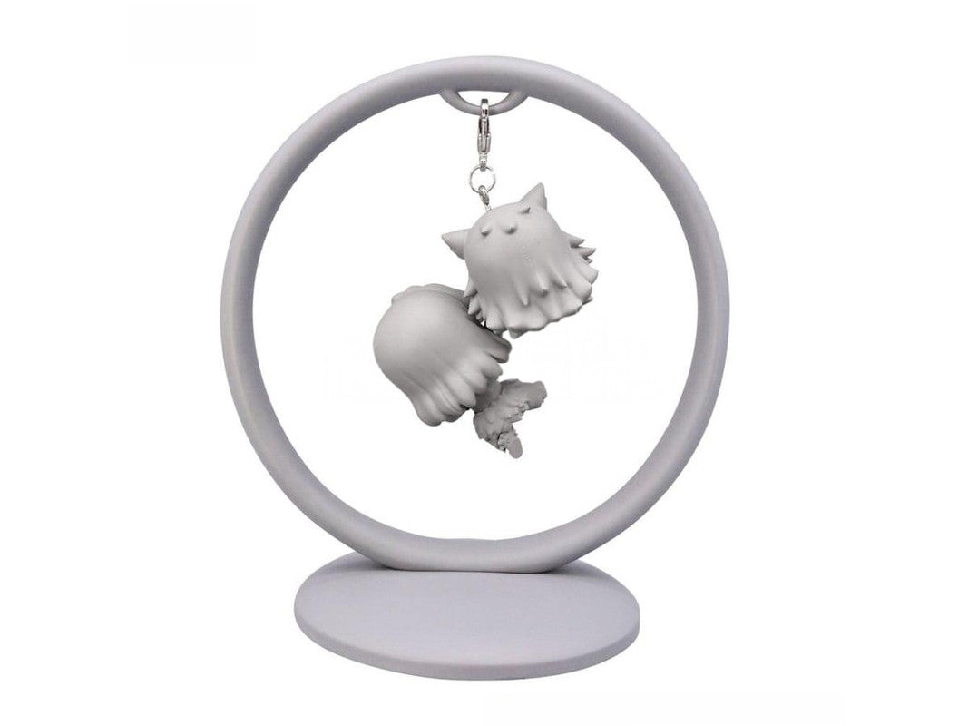Gray resin keychain charm featuring a stylized monster creature hanging from a ring stand