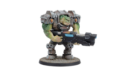 A detailed miniature of a green-skinned, orc-like creature in heavy grey power armor holding a large futuristic rifle