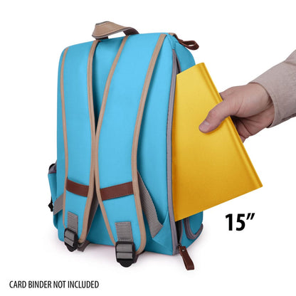 Hand inserting a 15-inch yellow binder into a blue backpack, demonstrating storage capacity.