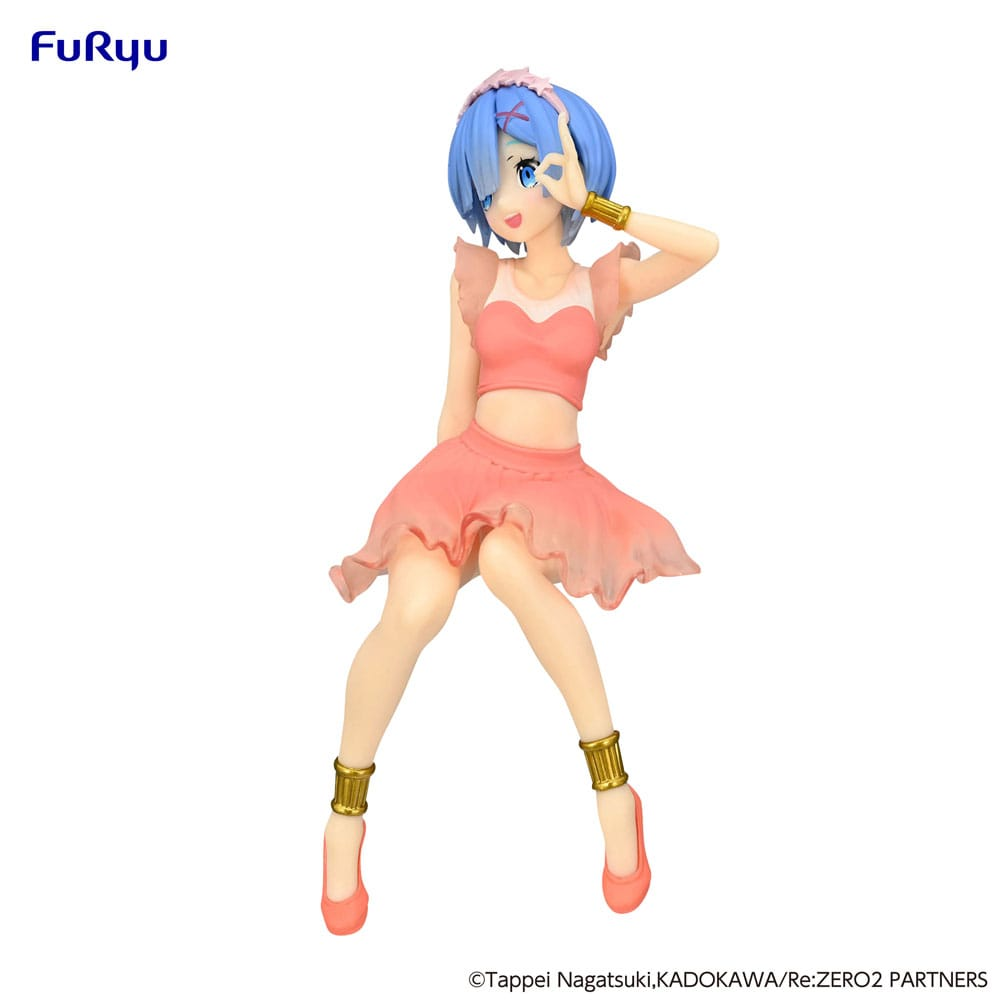 Rem seated on party-themed base with hands on knees, smiling gently