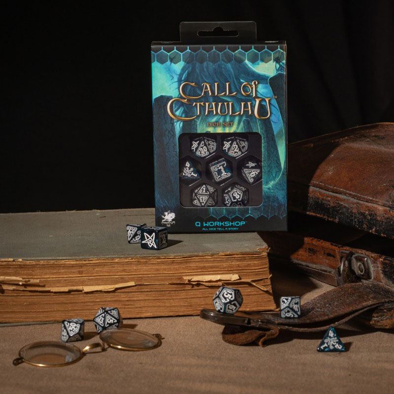Call of Cthulhu Dice Set with black and white Elder Sign dice displayed with an antique book and magnifying glass perfect for role-playing games