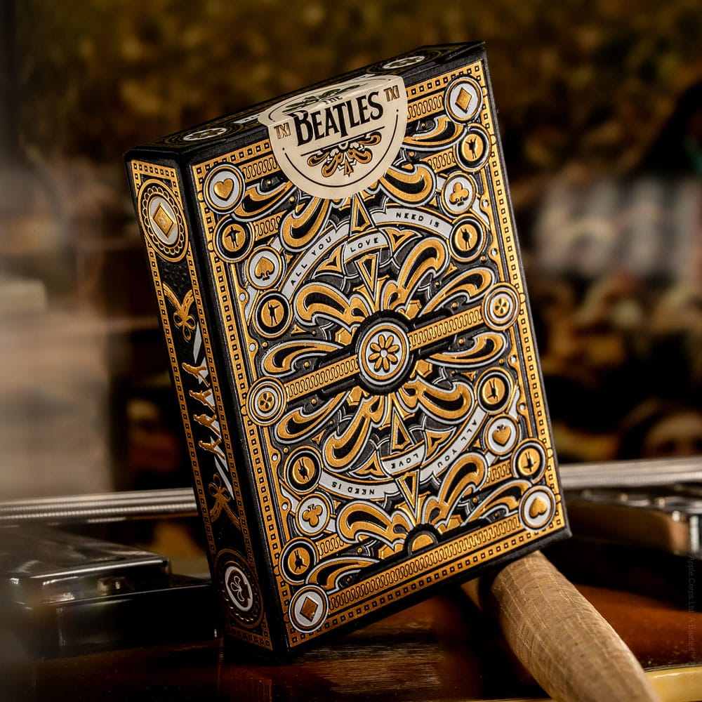 A black and gold ornate playing card tuck box featuring The Beatles logo and "All You Need Is Love"