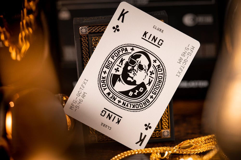Custom King of Clubs card showing Notorious B.I.G.'s portrait, displayed near gold chains