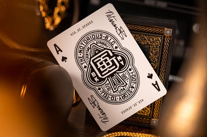 Custom Notorious B.I.G. Ace of Spades playing card leaning against a black deck box with gold trim