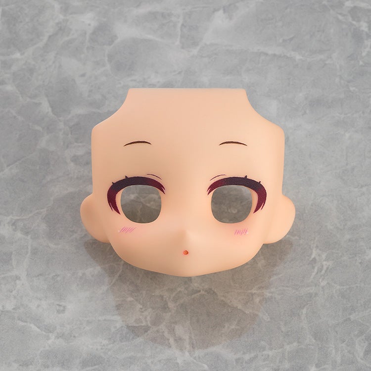 Angled view of Peach face plate with makeup, highlighting blush and details