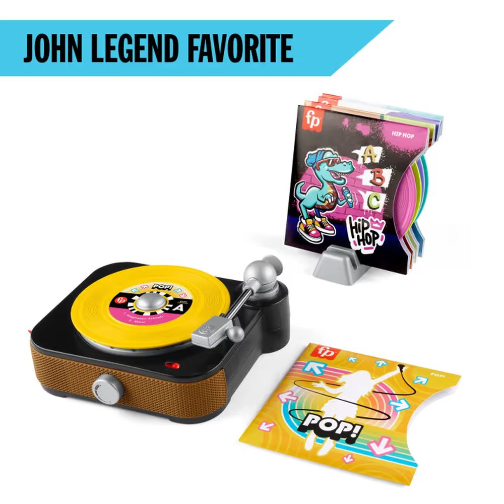 Fisher-Price toy record player with yellow record, colorful album covers in a stand, and a 'POP!' record. 'JOHN LEGEND FAVORITE' text