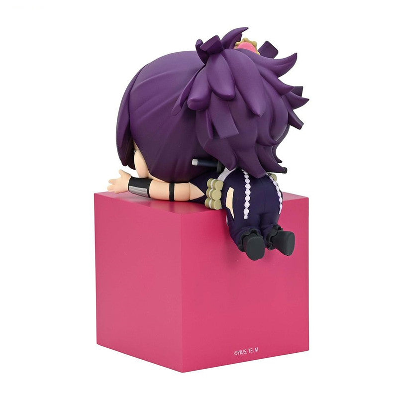 Chibi anime figure of a purple-haired character in a navy outfit resting on a pink cube