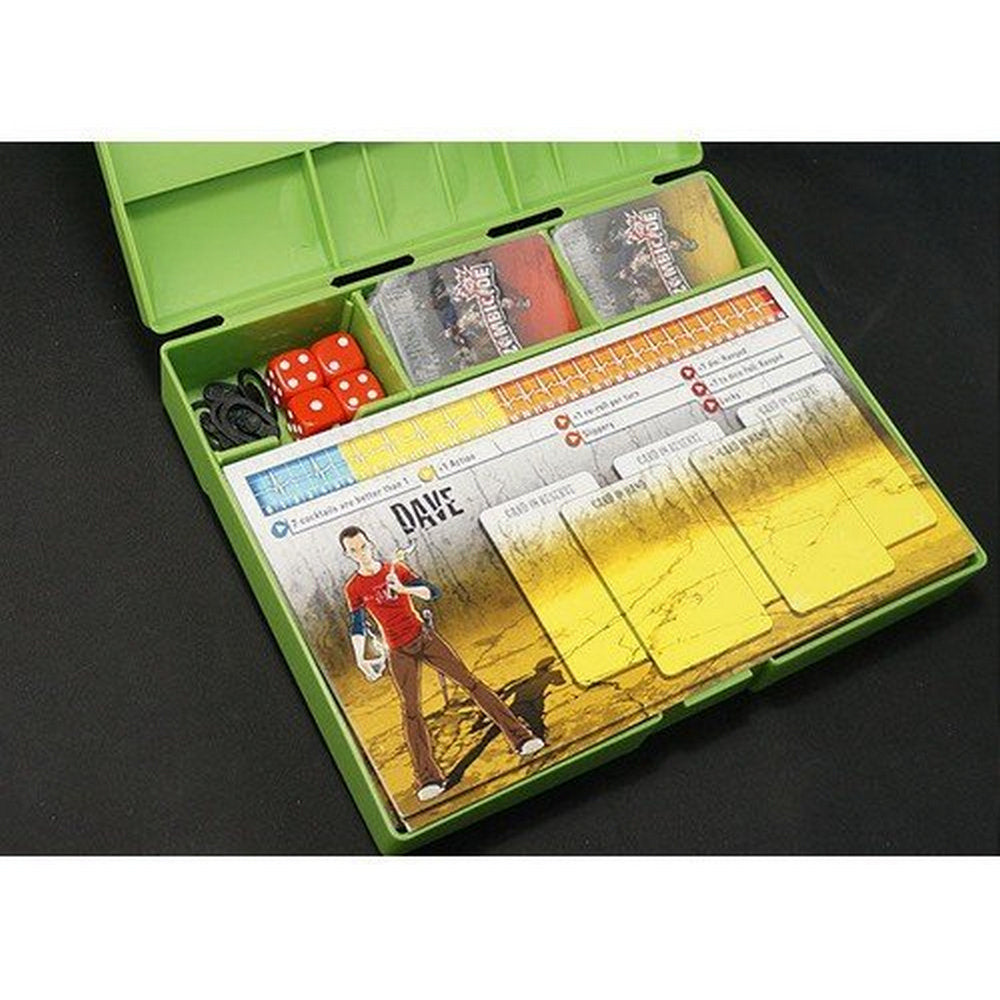 An open green Zombicide board game organizer showing red dice, a &quot;Dave&quot; character card, and stacked game cards